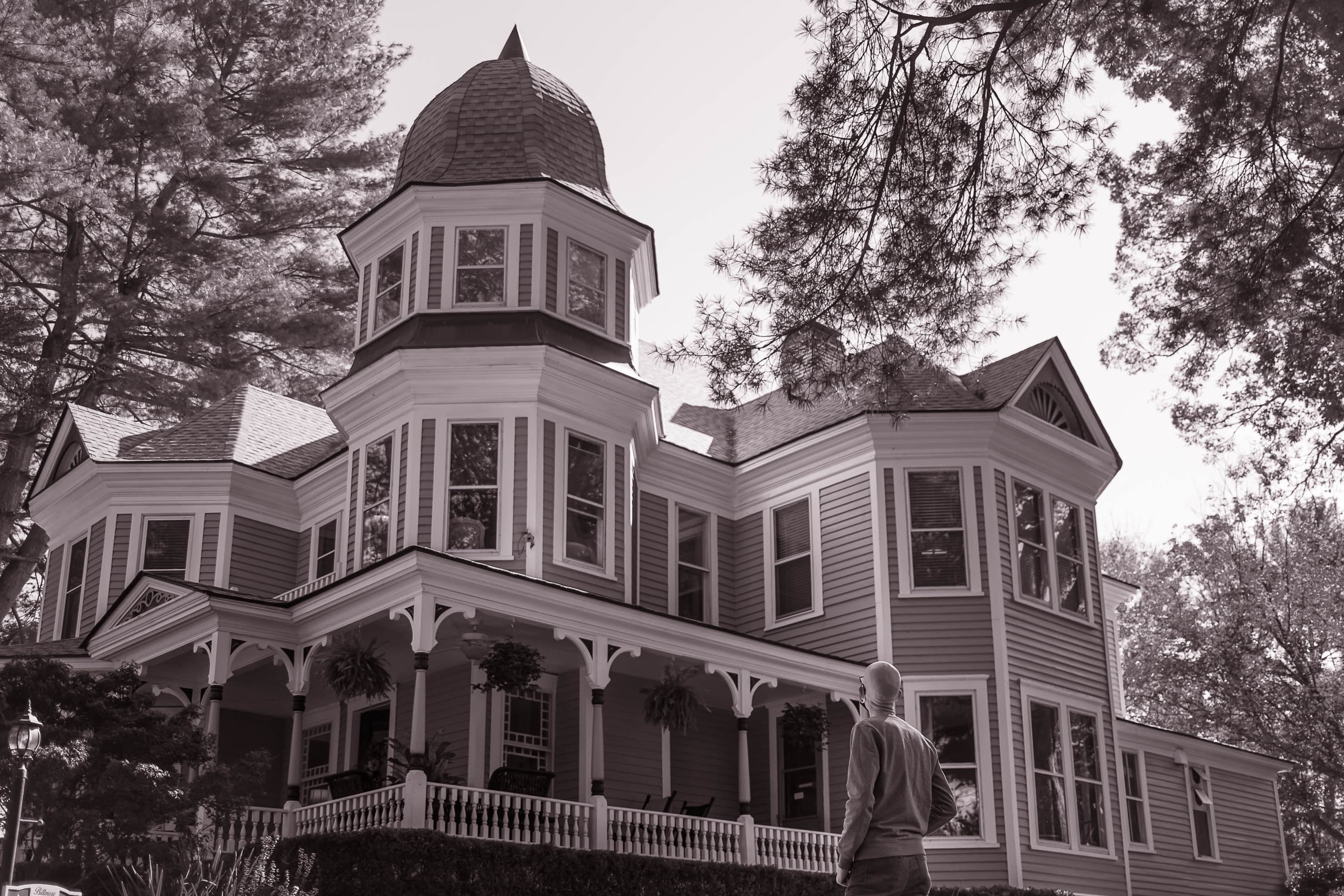 Photography: JD Crane An investigator regarding a turreted Victorian house from the front walk