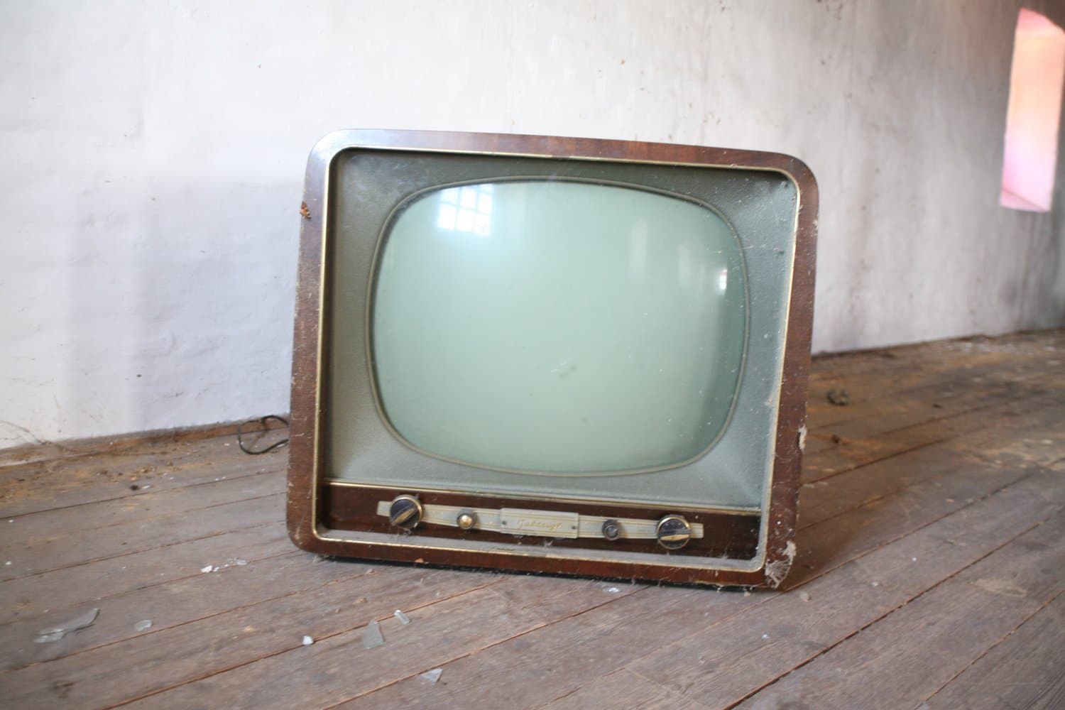 A vintage television set standing in an empty room